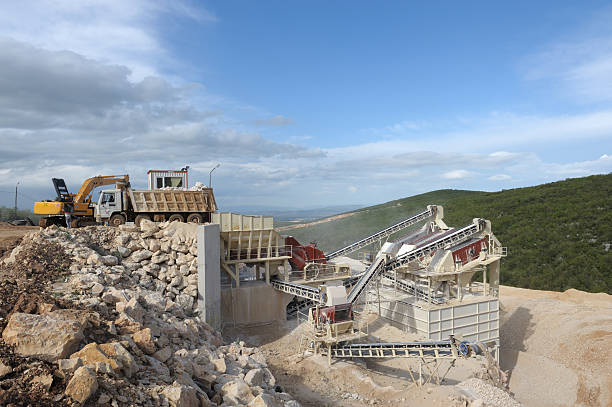 "Stone quarry with silos, conveyor belts and piles of stones" "Stone quarry with silos, conveyor belts and piles of stones"