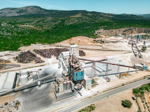 Aerial view of a mining quarry with heavy machinery, surrounded by forest. Aerial view of a mining quarry with heavy machinery, surrounded by forest.