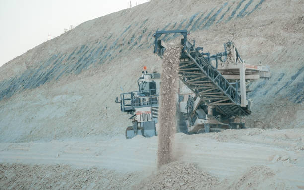 swip Quarry harvester unit with heavy equipment. Construction industry. building a road and hotel on the Dead Sea, Israel. horizontal blue sky and white clouds background