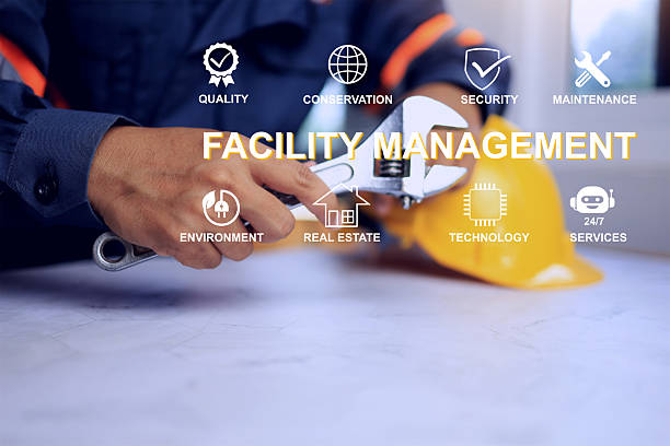 Facility management concept with technician holding torque wrench on desk ready to service manner