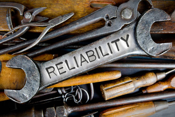 Photo of various tools and instruments with RELIABILITY letters imprinted on a clear wrench surface
